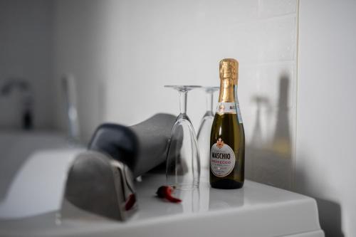 a bottle of champagne sitting on a counter at Bed&Dreams in Salento - Bilocale deluxe con vasca idromassaggio in Guagnano