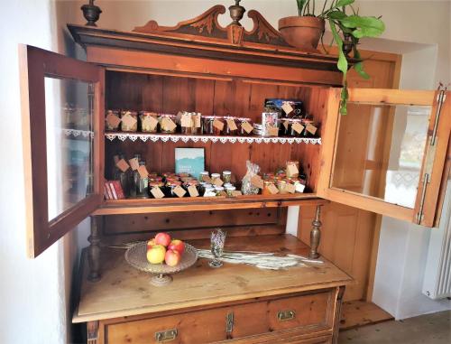 a cabinet with a bowl of fruit on a table at FP Muehlmann&Schoen in Innervillgraten