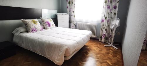 1 dormitorio con cama blanca y ventana en ALMAALQUILER Gran Maestre 3, en Almagro