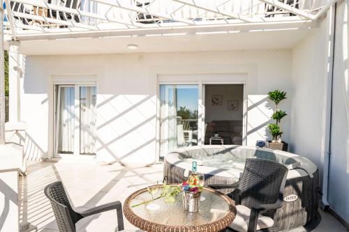 a patio with a table and chairs on a balcony at Apartments Blažević in Mlini