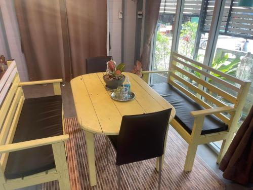 a wooden table with a potted plant on top of it at Hunny Home in Ko Yao Noi