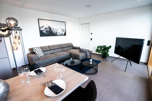 a living room with a couch and a table at Max Lodging Serviced Apartments in Munich
