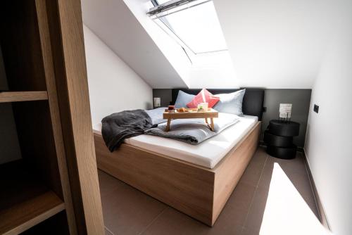 a bedroom with a bed with a table on it at Max Lodging Serviced Apartments in Munich