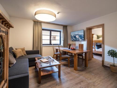 a living room with a couch and a table at Alpine Homes - Hopfgarten in Hopfgarten im Brixental