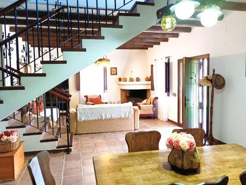 un salon avec un escalier et une salle à manger dans l'établissement Casa rural Carratraca Finca Los viñazos, à Carratraca