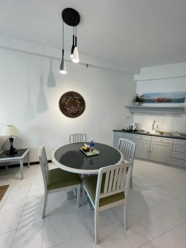 a kitchen with a table and chairs in a room at Rainbow paradise at Tanjung Bungah in Tanjung Bungah