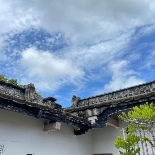 an old stone bridge with the sky in the background at Waiting for the Blossoms B&B Tea House in Shantou