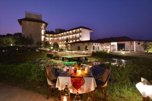 a dinner table in front of a building at night at Bhanu The Fern Forest Resort & Spa, Jambughoda in Jambughoda