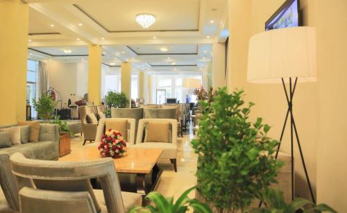 a lobby with couches and a table and chairs at Swiss Inn Nexus Hotel in Addis Ababa