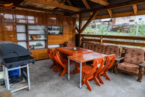 a dining room with a table and chairs and a grill at Beskidzki Klimat Jaśliska in Jaśliska