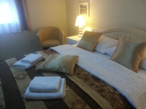 a bedroom with a large bed with two pillows at Villa Jelena in Zadar