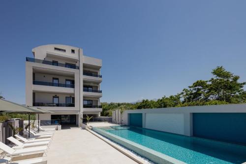 an external view of a building with a swimming pool at Aurora apartments in Chania