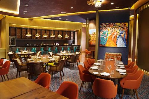 a restaurant with tables and chairs and a bar at Al Gassar Resort in Doha