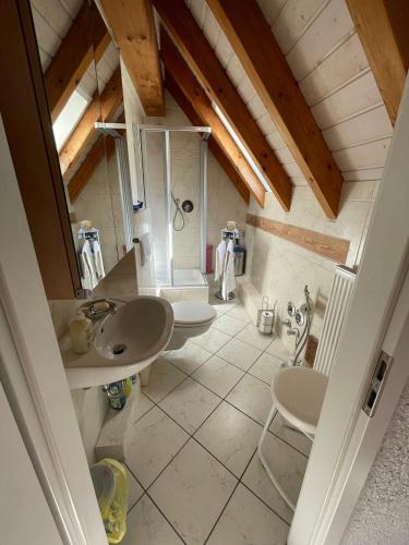 a attic bathroom with two sinks and a shower at Glattbacher Hof in Lindenfels