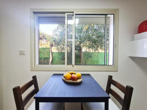 a bowl of fruit on a table in front of a window at SAMA Tarshiha in Ma'alot Tarshiha