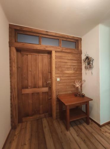 a wooden door and a table in a room at Haus kremsbrücke in Kremsbrücke