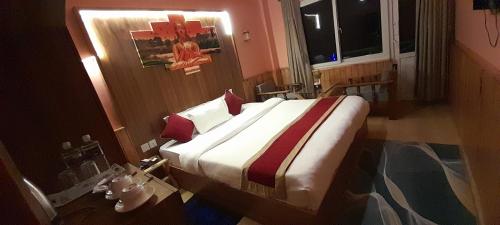 a bedroom with a large bed with red pillows at Paradise Villa in Nagarkot