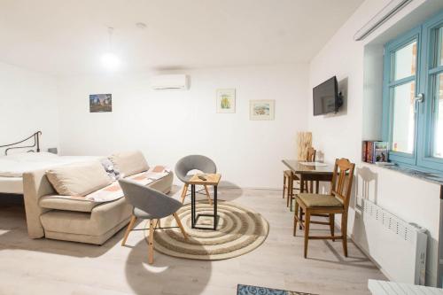a living room with a bed and a table at Apartmány Uprostřed zeleně in Lednice