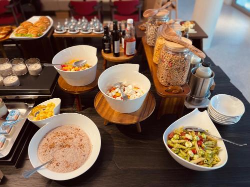 a table topped with bowls of food and other foods at Hotel Ambasador in Split