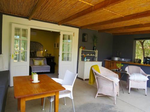a living room with a table and chairs at Olive Grove Pip in Prince Albert