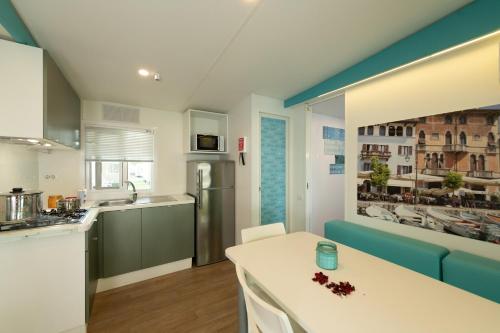 a kitchen with a white counter top in a room at San Francesco Camping Village in Desenzano del Garda