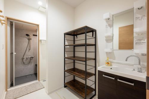 a bathroom with a shower and a sink at RuPow Lodge - walking distance to Rusutsu Resort in Rusutsu