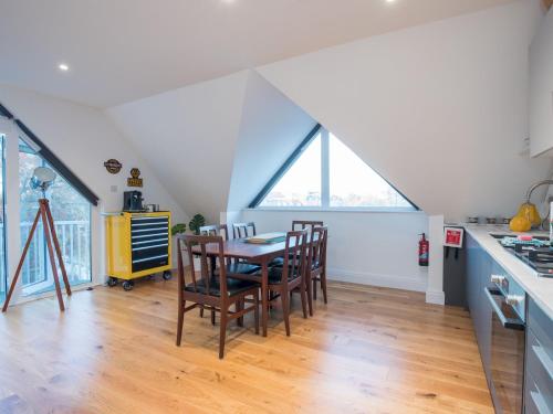 a kitchen and dining room with a table and chairs at Radiant Penthouse on the Banks of the Thames in Windsor