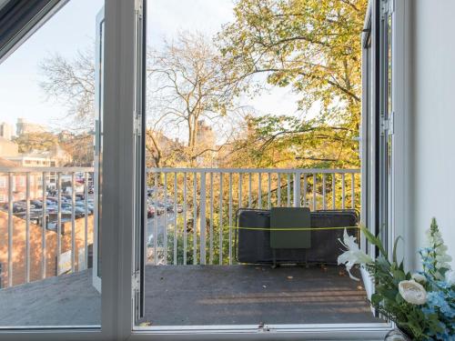 an open door to a balcony with a view of a parking lot at Radiant Penthouse on the Banks of the Thames in Windsor
