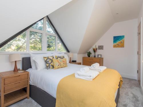 a bedroom with a bed and a large window at Radiant Penthouse on the Banks of the Thames in Windsor