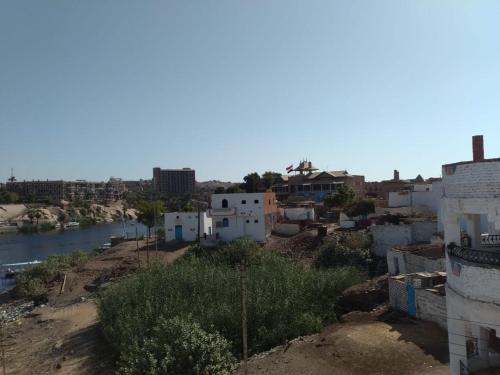 a view of a city with a river and buildings at Zekry nubian guest house in Aswan