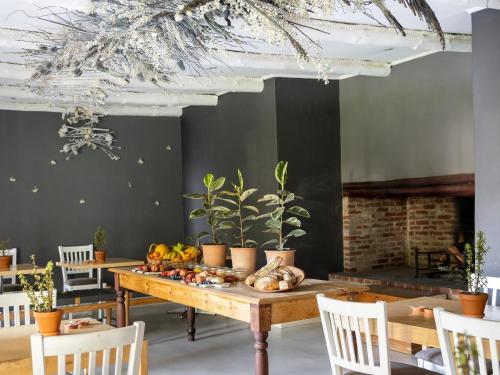 a dining room with a table with fruits and vegetables on it at Greyton Lodge in Greyton