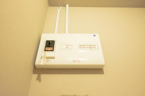 a white appliance is hanging on a wall at Woodhouse Yasunaya in Lake Toya
