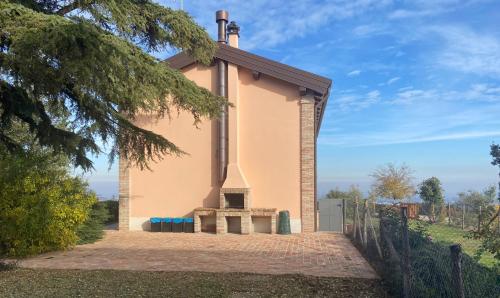 a small house with a bench in front of it at Rio Sabbioso in Dozza