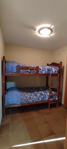 a bedroom with two bunk beds in a room at Apartamentos Boabdil in Sierra Nevada