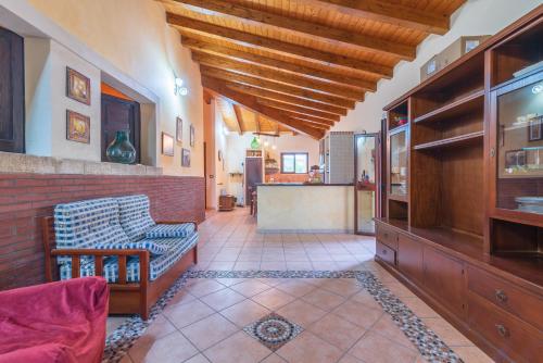 a living room with a couch and a counter at Villa Gabri in Carlentini