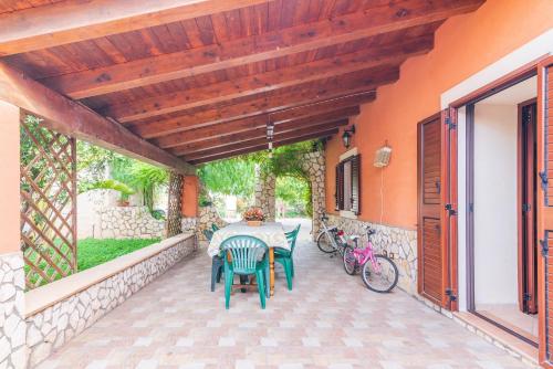 a patio with a table and chairs on it at Villa Gabri in Carlentini