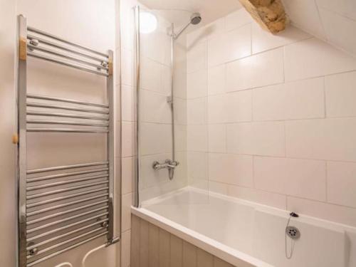 a white bathroom with a shower and a tub at Park Cottage in Minchinhampton