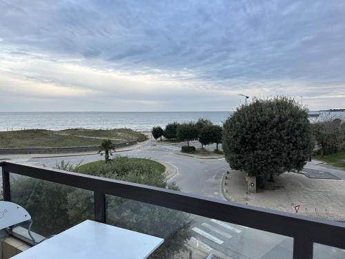 a balcony with a view of a road and the ocean at APARTMENT DAMGAN VUE MER in Damgan