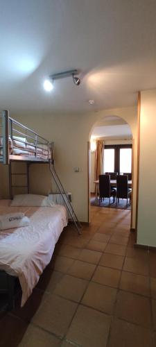 a bedroom with a bunk bed and a dining room at Apartamentos Boabdil in Sierra Nevada