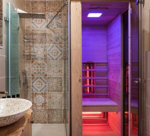a bathroom with a purple shower with a sink at Palazzo di Irene in Chania Town