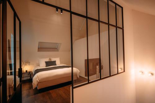 Ein Bett oder Betten in einem Zimmer der Unterkunft Sud d'Anvers