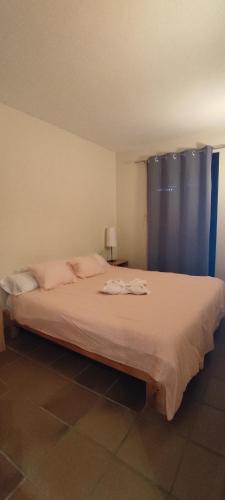 a bedroom with a large bed with a blue curtain at Apartamentos Boabdil in Sierra Nevada