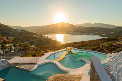 a resort with a pool and a view of a lake at Agalia Luxury Suites in Tzamaria
