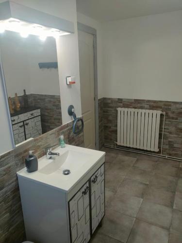 a bathroom with a sink and a mirror at Casa Roiz in Santillana del Mar