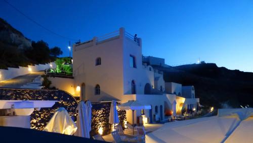 a white building with lights in front of it at night at Kokkinos Villas in Akrotiri