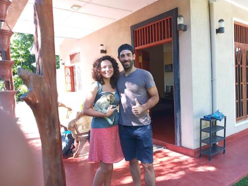 a man and a woman standing in front of a house at Kande Gedara Resort (කන්දෙ ගෙදර) in Monaragala