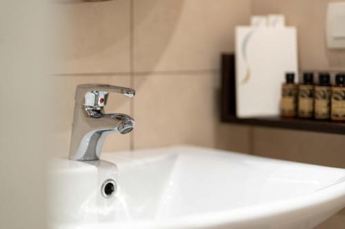 a sink in a bathroom with a faucet at Symphony Residence in Vóthon