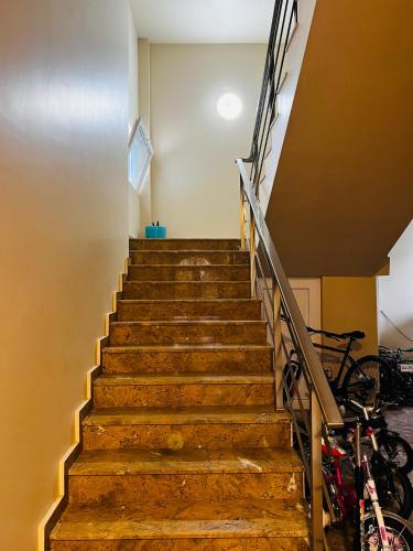 a set of stairs in a building with bikes at Apartments NITA in Batumi
