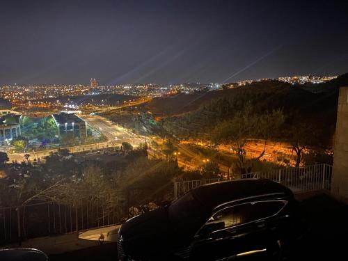 a view of a city at night with lights at Jerusalem MALHA View in Jerusalem