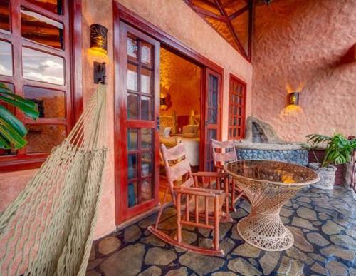 a room with a table and chairs in a house at Peace Lodge in Vara Blanca